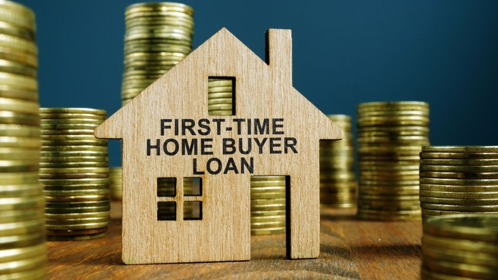 First-time home buyer loan sign on model of house