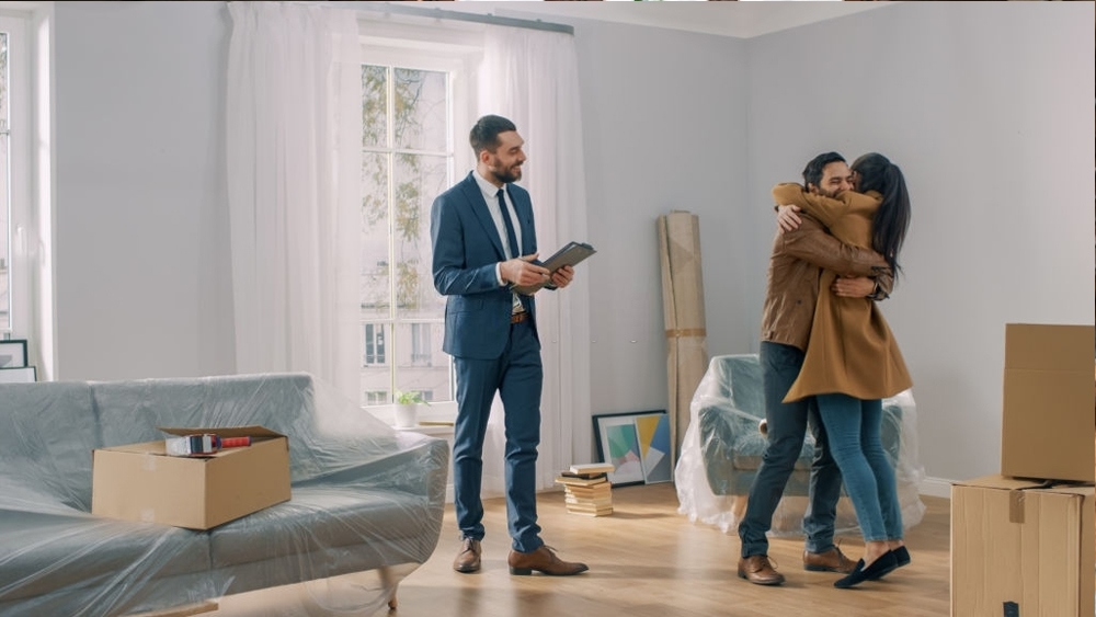 Real estate agent shows apartment to young couple