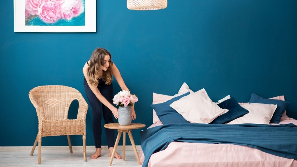 Woman decorating a home with flowers