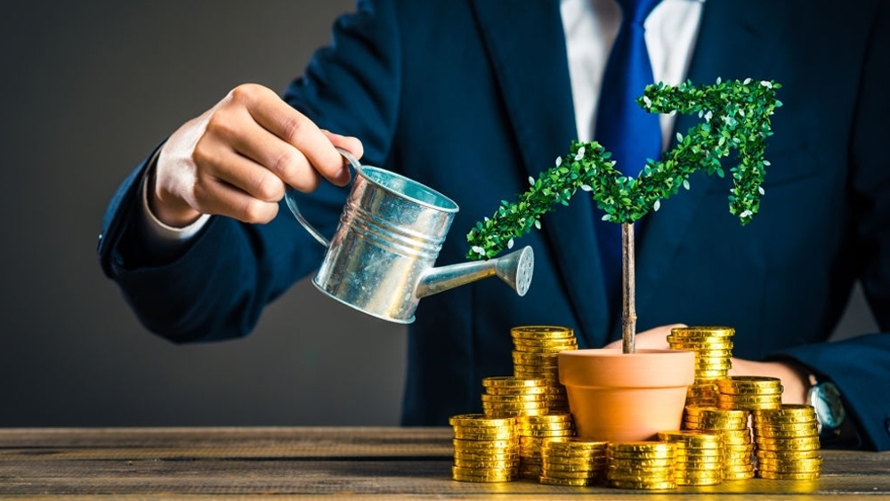 Businessman with plants and gold