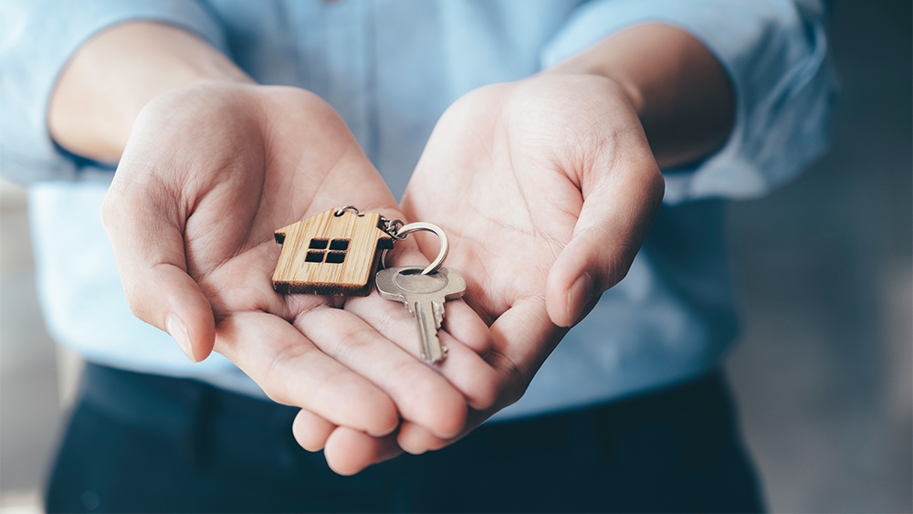 Giving offering demonstration holding house key