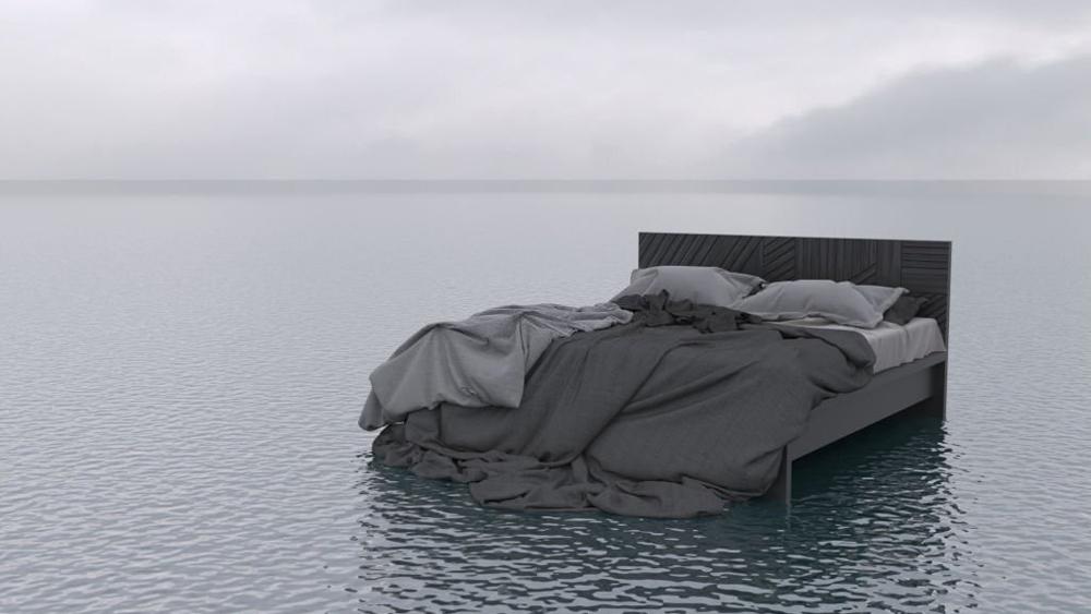 The bed floats on the surface of a calm sea or ocean in cloudy weather outdoor