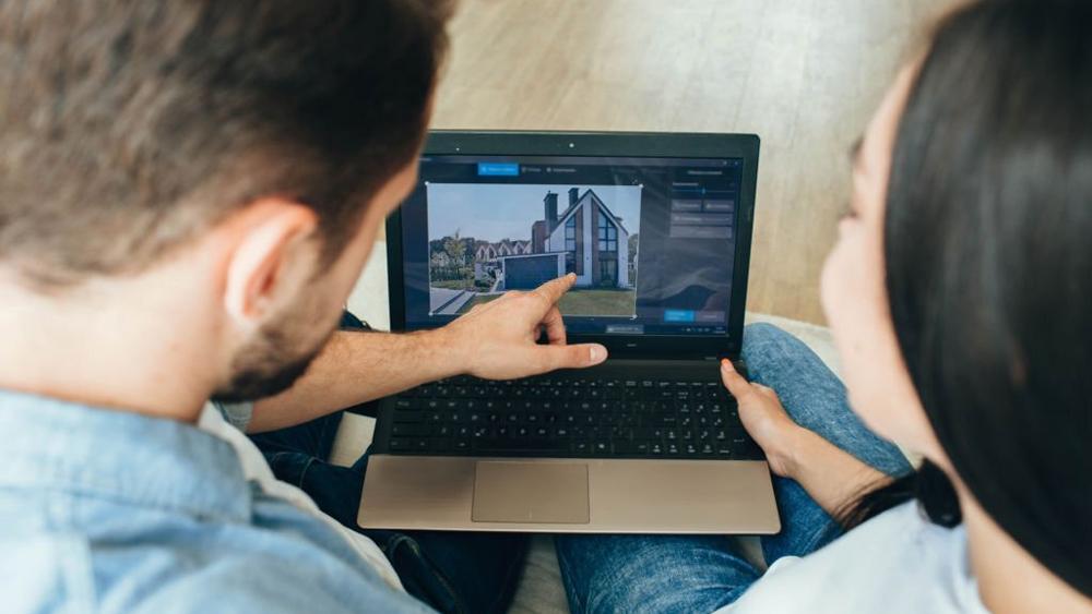 Couple searching and choosing new house on the internet