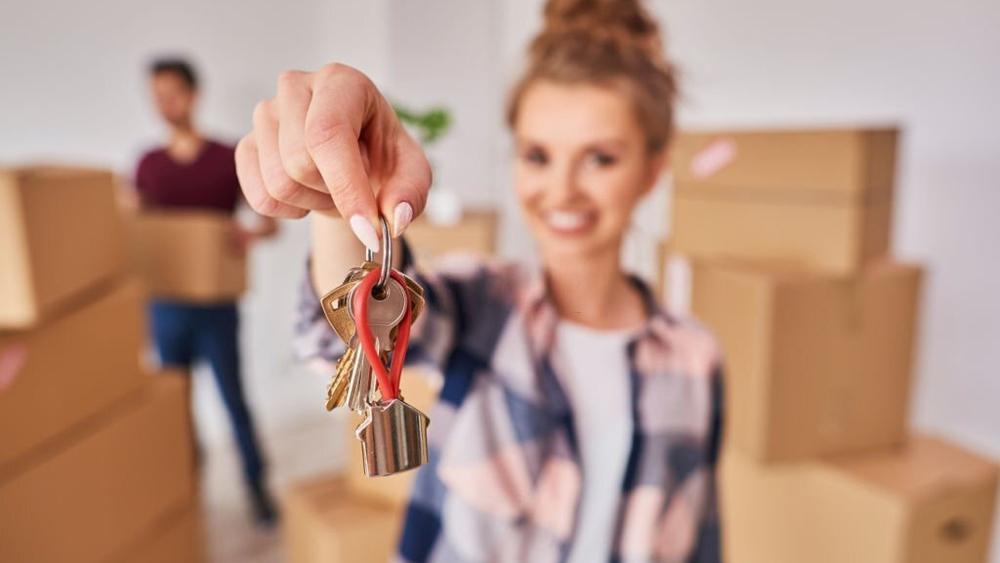 Woman showing keys of rented apartment