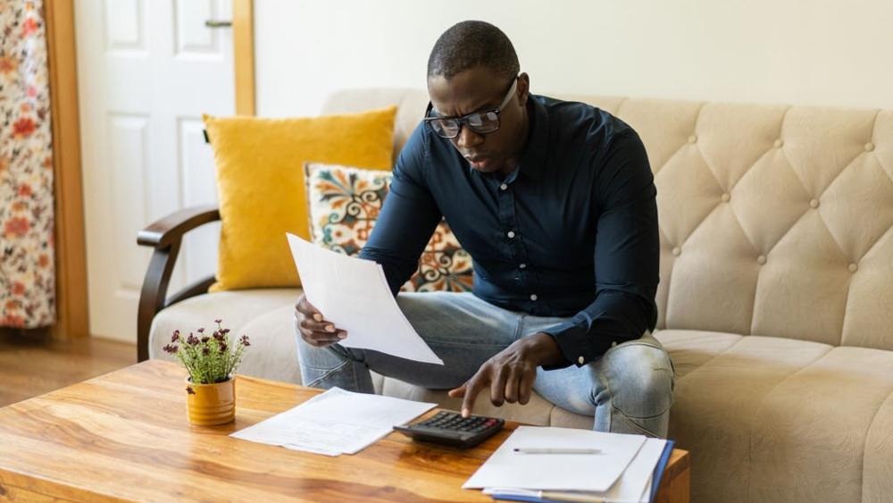 A man calculating his home finances