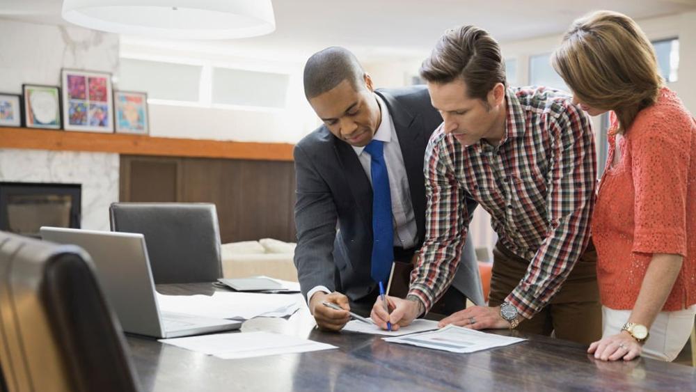 Couple signing documents for buying home