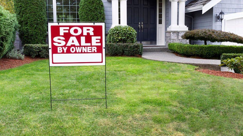 Modern home for sale with sign in front of yard