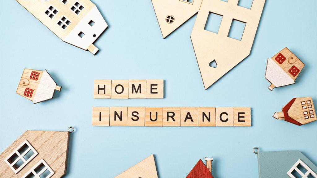 Home insurance message and wooden houses