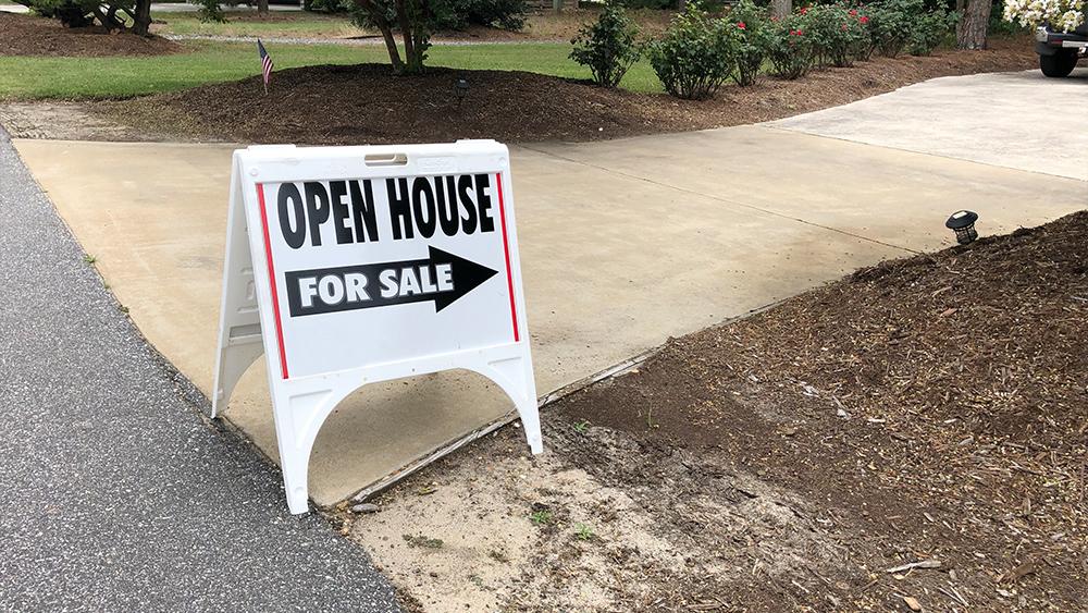 Real estate open house for sale sign at front entrance