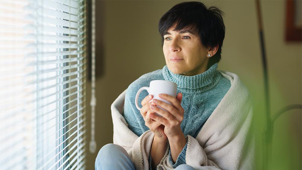 Woman feeling cold because of not winterizing doors windows