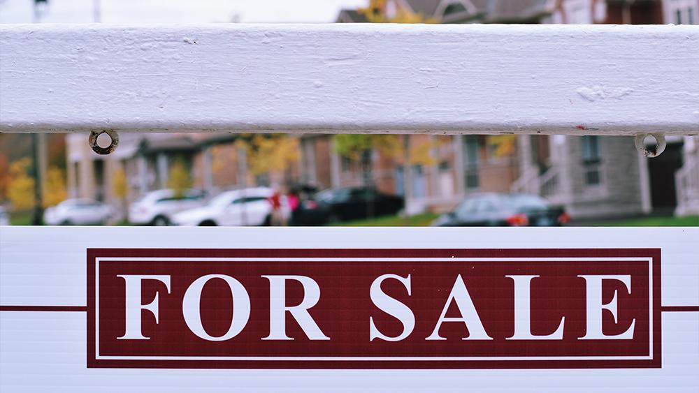 House for sale sign on a street