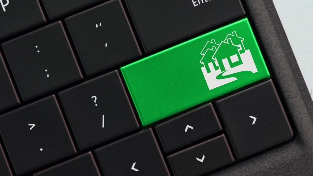 Housing concept on computer keyboard with green key
