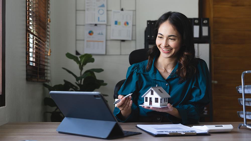 Young female real estate advisor talking with client