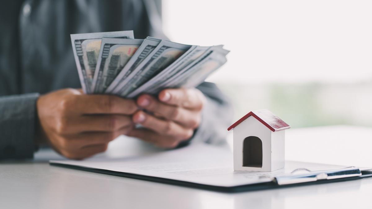 Male real estate agent hands counting money