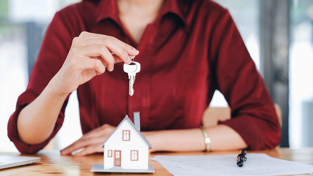 Home seller holding home key