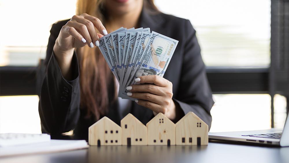 Female real estate agent counting money