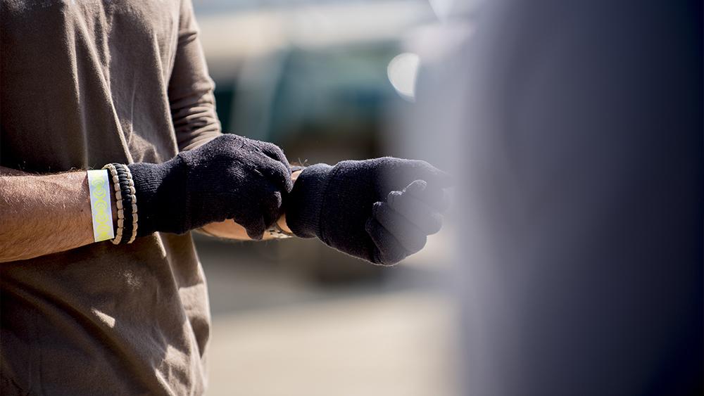 Selective focus shot of a male wearing a black glove