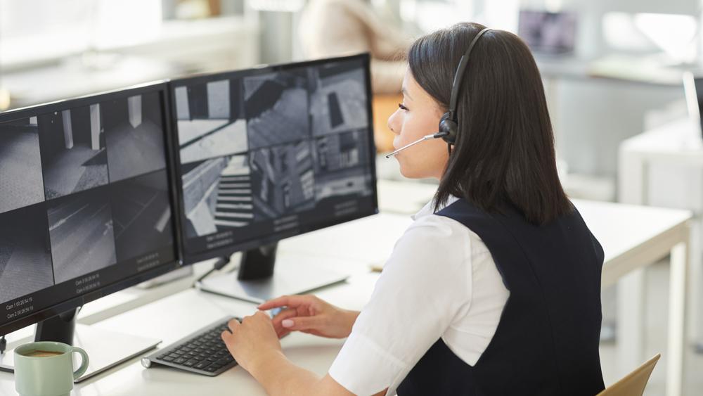 Young woman in a CCTV monitoring room